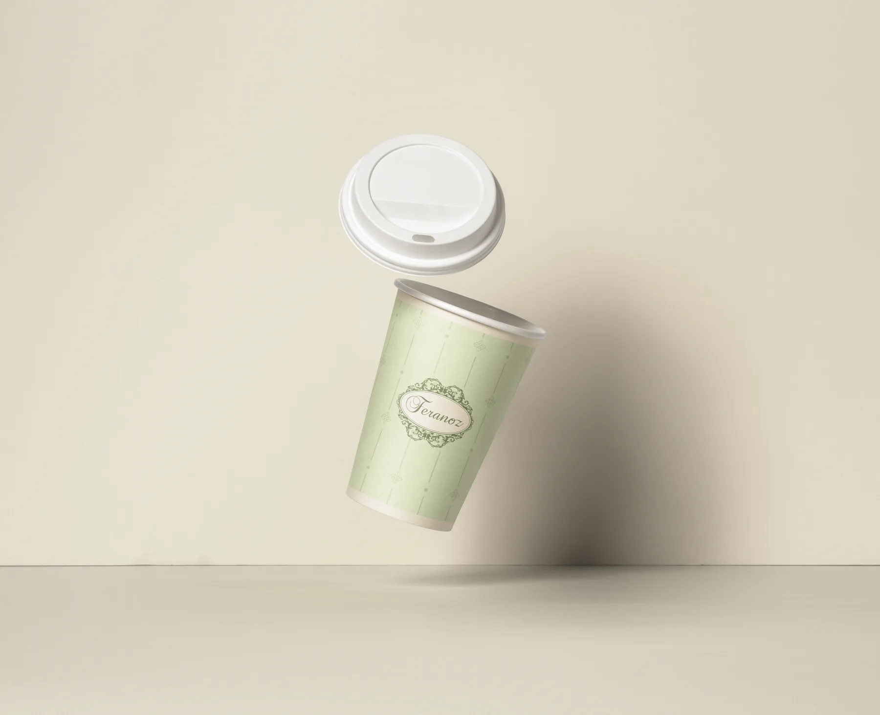 A pale green Feranoz paper coffee cup floating with its lid lifted