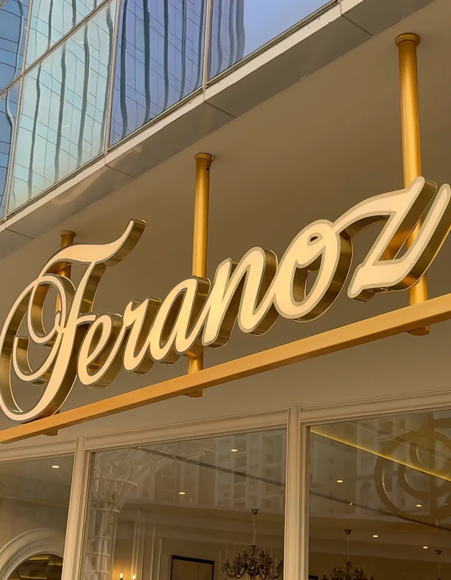 The gold Feranoz sign over the cafe’s glass front