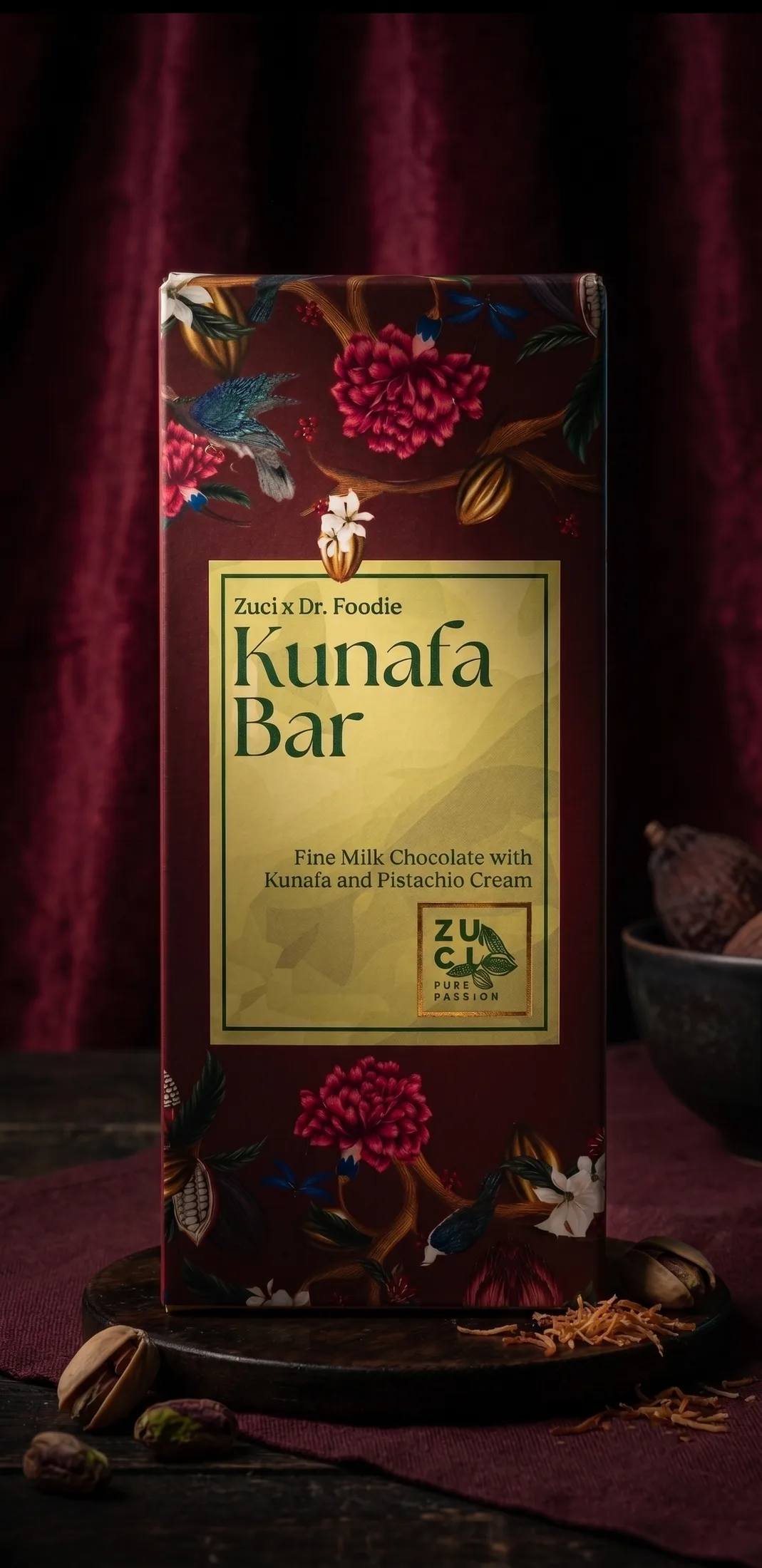The Kunafa Bar box with a burgundy floral pattern and a gold label